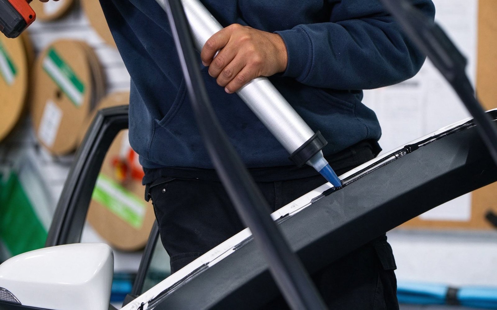 Professional automotive applicator gun applying consistent triangular urethane bead for ADAS windshield installation
